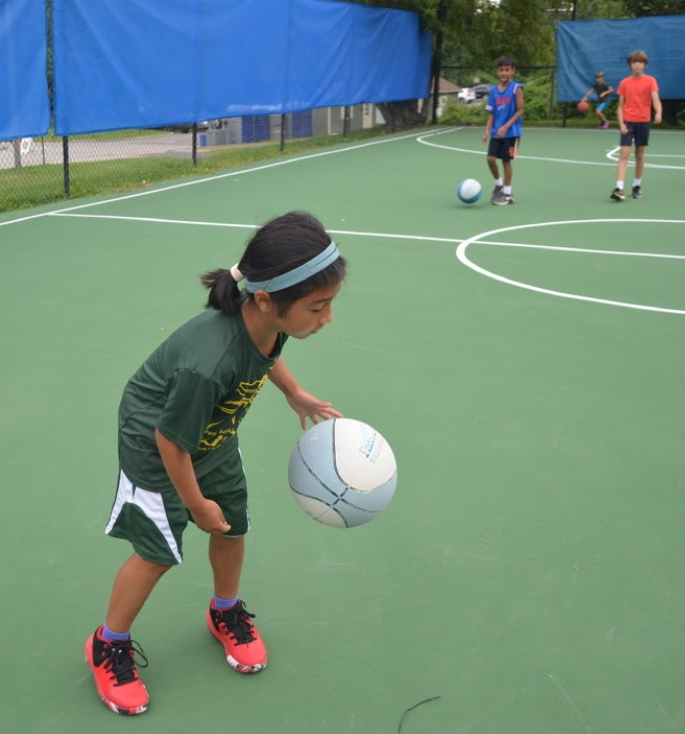 girl playing basketball at summer camp
