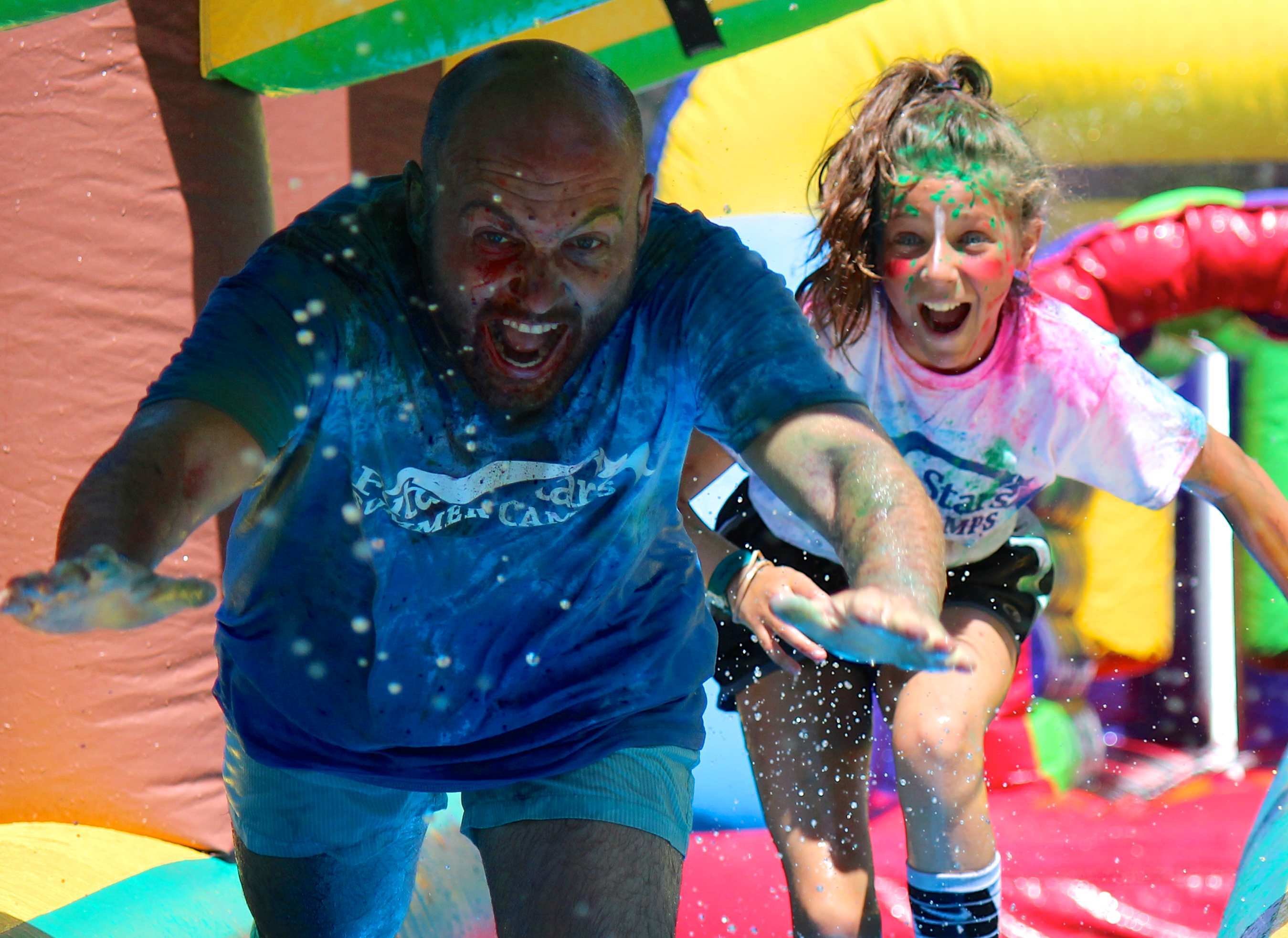 multi sport - coach darren and girl slip slide color war