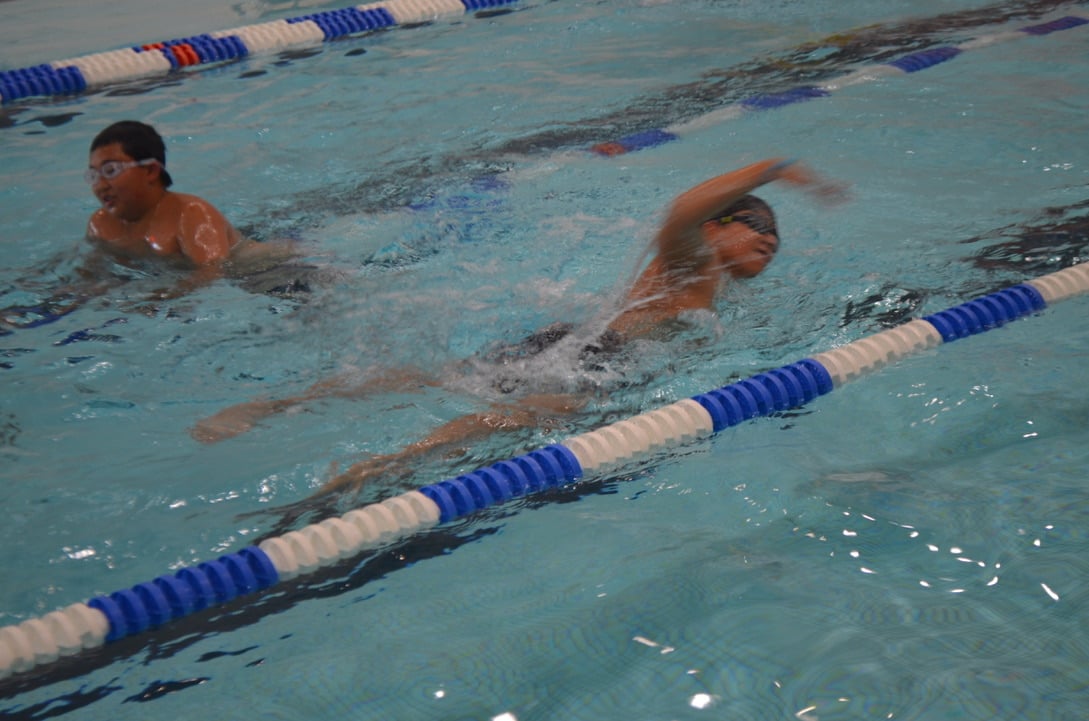 Kids swimming in pool during camp day